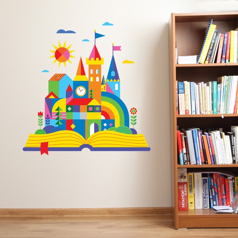 May include: A colorful, geometric castle illustration on an open book with a rainbow, sun, and clouds. The castle is made of colorful blocks and has a clock on the side.