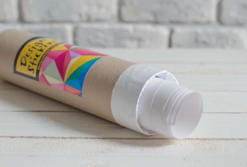 May include: A rolled up poster with a white backing and a brown cardboard tube. The tube has a colorful geometric design and the text "Design Stickery" printed on it.