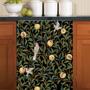May include: A black and green dishwasher magnet with a repeating pattern of pomegranates, leaves, and birds. The birds are brown, red, and white.