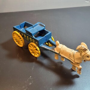 Cast iron express cart pulled by goat, vintage collectible toy, 8 inches long, hand painted blue and yellow, cast iron figurine