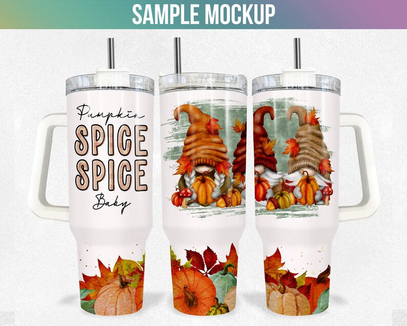 May include: White stainless steel tumbler with a handle. The tumbler features a autumnal design with gnomes, pumpkins, and leaves. The text "Pumpkin Spice Spice Baby" is printed on the tumbler.