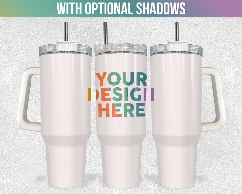 May include: Three white stainless steel travel mugs with handles and lids. The middle mug has the text "YOUR DESIGN HERE" in colourful letters.