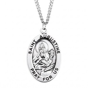 May include: Silver-toned oval pendant necklace featuring an image of Saint Augustine. The pendant has the words "Saint Augustine" and "Pray for Us" engraved around the image. The necklace has a delicate chain.