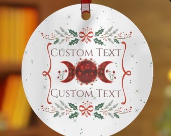 May include: White round Christmas ornament with a red and gold triple moon symbol, green holly leaves, and red berries. The ornament has the text "CUSTOM TEXT" on the top and bottom.