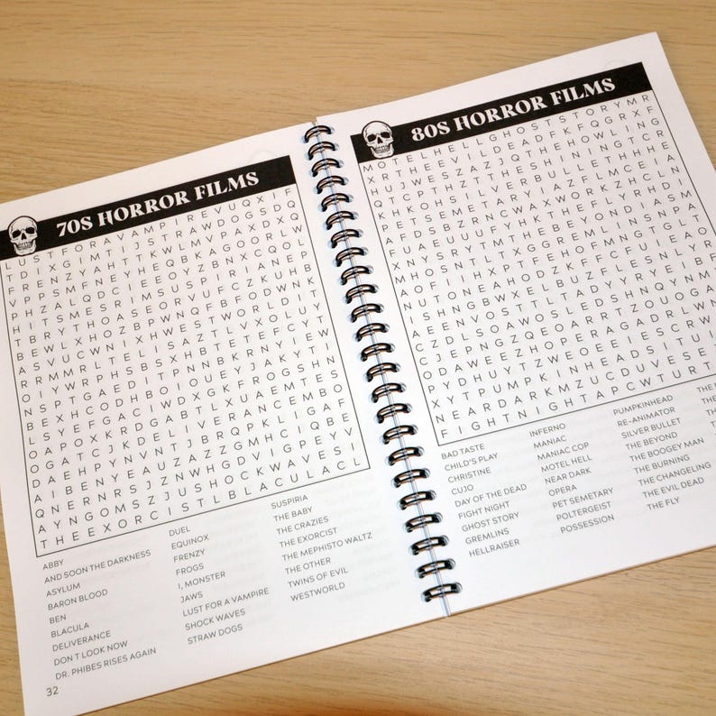 May include: Two open pages of a spiral bound book with a black and white word search puzzle on each page. The left page has the title "70s Horror Films" and the right page has the title "80s Horror Films".