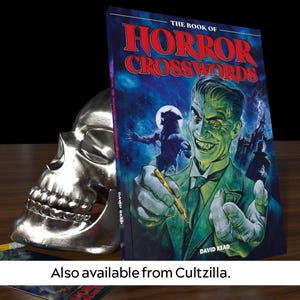 May include: A book titled "The Book of Horror Crosswords" with a green and blue cover featuring a man with a sinister smile and a werewolf in the background. The book is leaning against a silver skull.