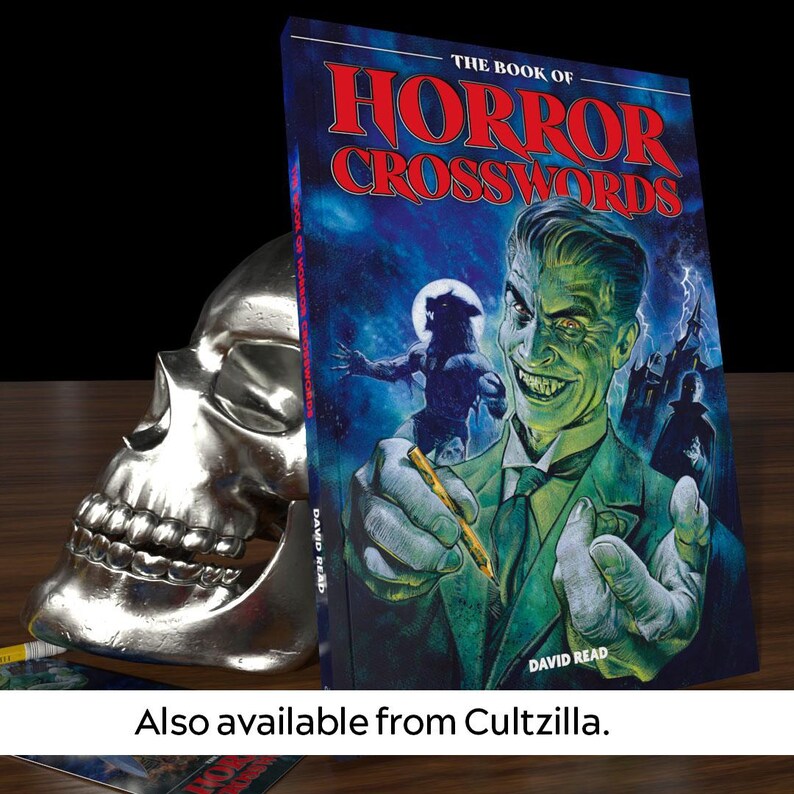 May include: A book titled "The Book of Horror Crosswords" with a green and blue cover featuring a man with a sinister smile and a werewolf in the background. The book is leaning against a silver skull.