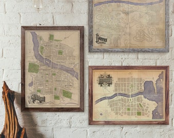 May include: Three framed vintage-style maps hang on a white brick wall. The maps feature detailed city layouts with streets, parks, and rivers, in shades of beige, green, and purple. Each map is enclosed in a wooden frame, with the top map in a gray frame.