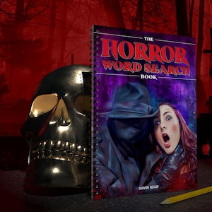 May include: A purple and black spiral bound notebook with the title "The Horror Word Search Book" by David Read. The cover features a man in a black hat and coat holding a woman with a scared expression.