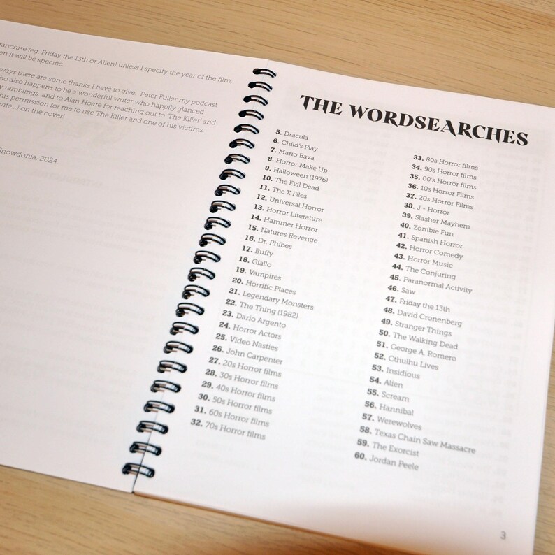 May include: A page from a book titled "The Wordsearches" with a list of horror movie titles, directors, and themes. The list includes titles like "Dracula", "Child's Play", "Halloween", "The Evil Dead", "The X Files", "Universal Horror", "Hammer Horror", "Nature's Revenge", "Dr. Phibes", "Buffy", "Giallo", "Vampires", "Horrific Places", "Legendary Monsters", "The Thing", "Dario Argento", "Horror Actors", "Video Nasties", "John Carpenter", "20s Horror Films", "30s Horror Films", "40s Horror Films", "50s Horror Films", "60s Horror Films", "70s Horror Films", "80s Horror Films", "90s Horror Films", "00s Horror Films", "10s Horror Films", "20s Horror Films", "J-Horror", "Slasher Mayhem", "Zombie Fun", "Spanish Horror", "Horror Comedy", "Horror Music", "The Conjuring", "Paranormal Activity", "Saw", "Friday the 13th", "David Cronenberg", "Stranger Things", "The Walking Dead", "George A. Romero", "Cthulhu Lives", "Insidious", "Alien", "Scream", "Hannibal", "Werewolves", "Texas Chain Saw Massacre", "The Exorcist", and "Jordan Peele".