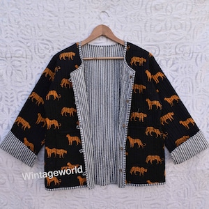 May include: A black quilted jacket with a striped lining and a pattern of orange tigers. The jacket has a button closure and long sleeves.