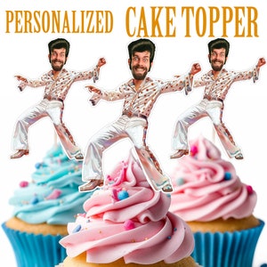 May include: Three personalized cake toppers featuring a cartoon man in a white jumpsuit with a gold star pattern. The man is wearing a brown belt and has a mustache and beard. The toppers are on top of cupcakes with pink and blue frosting.