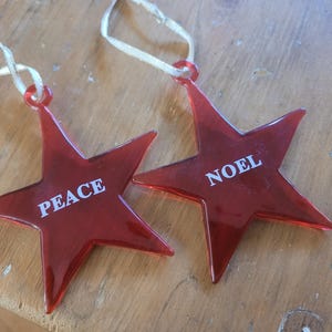 Red Plastic Star Ornaments - Noel & Peace w/White Ribbon Hangers - Set of 2