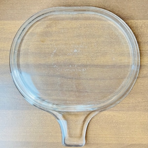 May include: Clear glass lid with a handle. The lid has the text "Anchor Hocking" and "Made in USA" printed on the bottom.