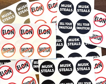 May include: A collection of round stickers with various designs. Some stickers feature the words "Musk Steals" in black text on a white background. Other stickers feature the words "Sell Your Swastica" in white text on a black background. Some stickers feature a red circle with a diagonal line through the word "Elon".