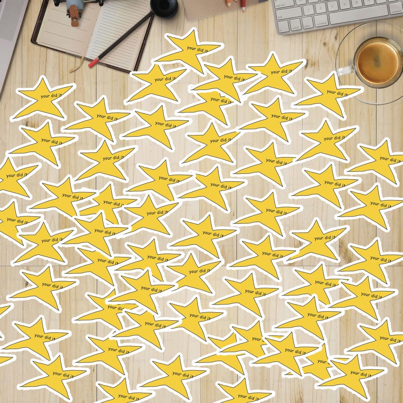 May include: A wooden surface covered with yellow star stickers that say "Your did it" on them.