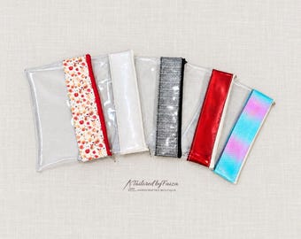 Estuche transparente de vinilo con cremallera y detalles holográficos, metálicos o florales, 8,5 x 5,25 pulgadas.