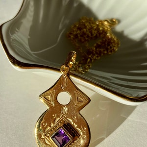 Tuareg gold plated pendant with amethyst or garnet stone in ethnic nomadic tribal shape. Bedouin African necklace. Saajie black owned shop Amethyst