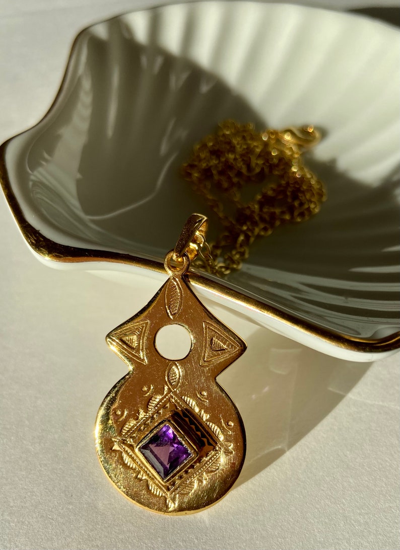 Tuareg gold plated pendant with amethyst or garnet stone in ethnic nomadic tribal shape. Bedouin African necklace. Saajie black owned shop Amethyst