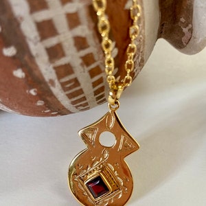 Tuareg gold plated pendant with amethyst or garnet stone in ethnic nomadic tribal shape. Bedouin African necklace. Saajie black owned shop Garnet