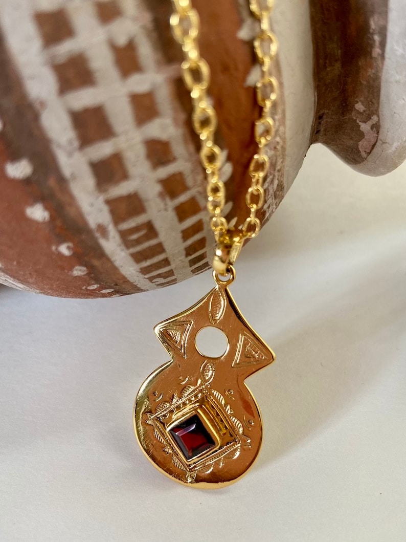 Tuareg gold plated pendant with amethyst or garnet stone in ethnic nomadic tribal shape. Bedouin African necklace. Saajie black owned shop Garnet