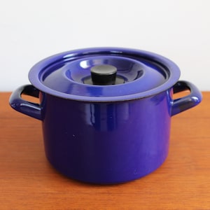 May include: A blue enamel saucepan with a lid and two handles. The lid has a black knob.