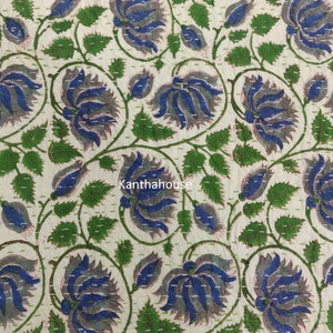 May include: A white fabric with a blue and green floral pattern. The fabric is quilted with a running stitch. The text "kantha house" is visible in the center of the image.