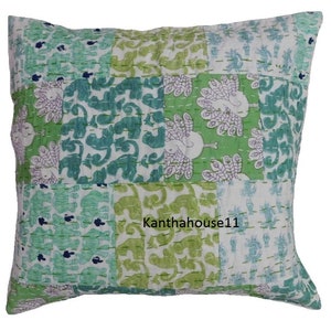 May include: A green and white patchwork cushion cover with a peacock design. The cushion cover is made of cotton and has a kantha stitch. The text "Kantha house11" is printed on the cushion cover.