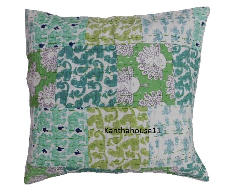 May include: A green and white patchwork cushion cover with a peacock design. The cushion cover is made of cotton and has a kantha stitch. The text "Kantha house11" is printed on the cushion cover.