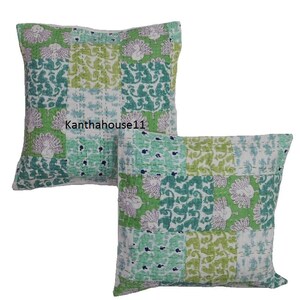 May include: Two green and white patterned cotton pillow covers with a peacock design. The pillow covers are made of kantha fabric, a traditional Indian hand-stitched fabric.