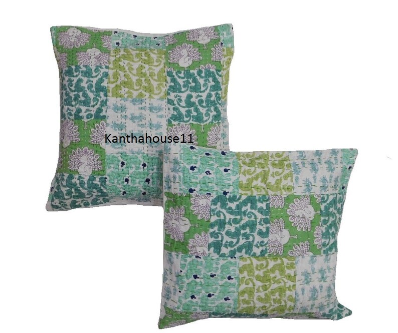 May include: Two green and white patterned cotton pillow covers with a peacock design. The pillow covers are made of kantha fabric, a traditional Indian hand-stitched fabric.