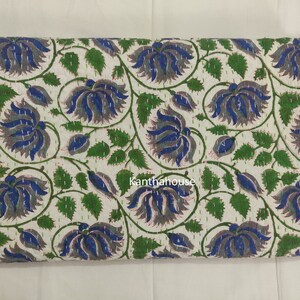 May include: White cotton fabric with a floral pattern in shades of blue, green, and gray. The fabric is quilted and has a hand-stitched look. The text "Kantha House" is visible in the lower center of the fabric.