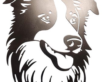 May include: A black metal silhouette of a Border Collie dog's head. The dog is looking to the right and has a happy expression.