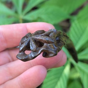 Hand-carved lignum vitae hair fork with chestnut leaf design, botanical green tone, fine hair accessory.