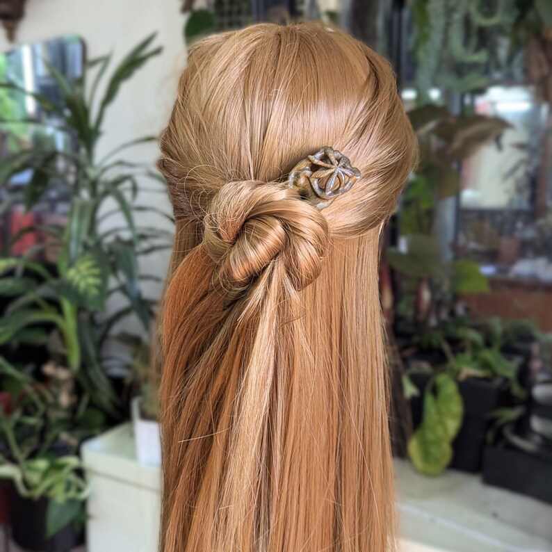 Hand-carved lignum vitae hair fork with chestnut leaf design, botanical green tone, fine hair accessory.