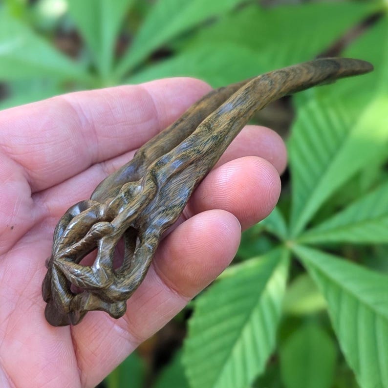 Hand-carved lignum vitae hair fork with chestnut leaf design, botanical green tone, fine hair accessory.