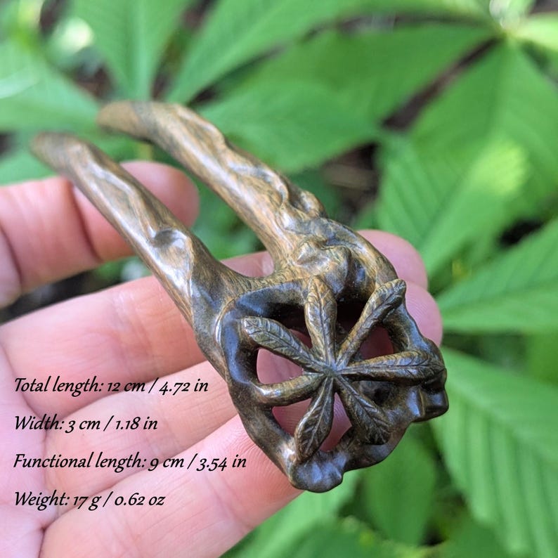Hand-carved lignum vitae hair fork with chestnut leaf design, botanical green tone, fine hair accessory.