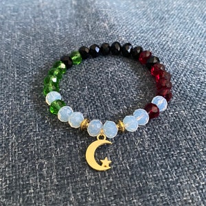 Palestine crystal bracelet with a moon pendant.