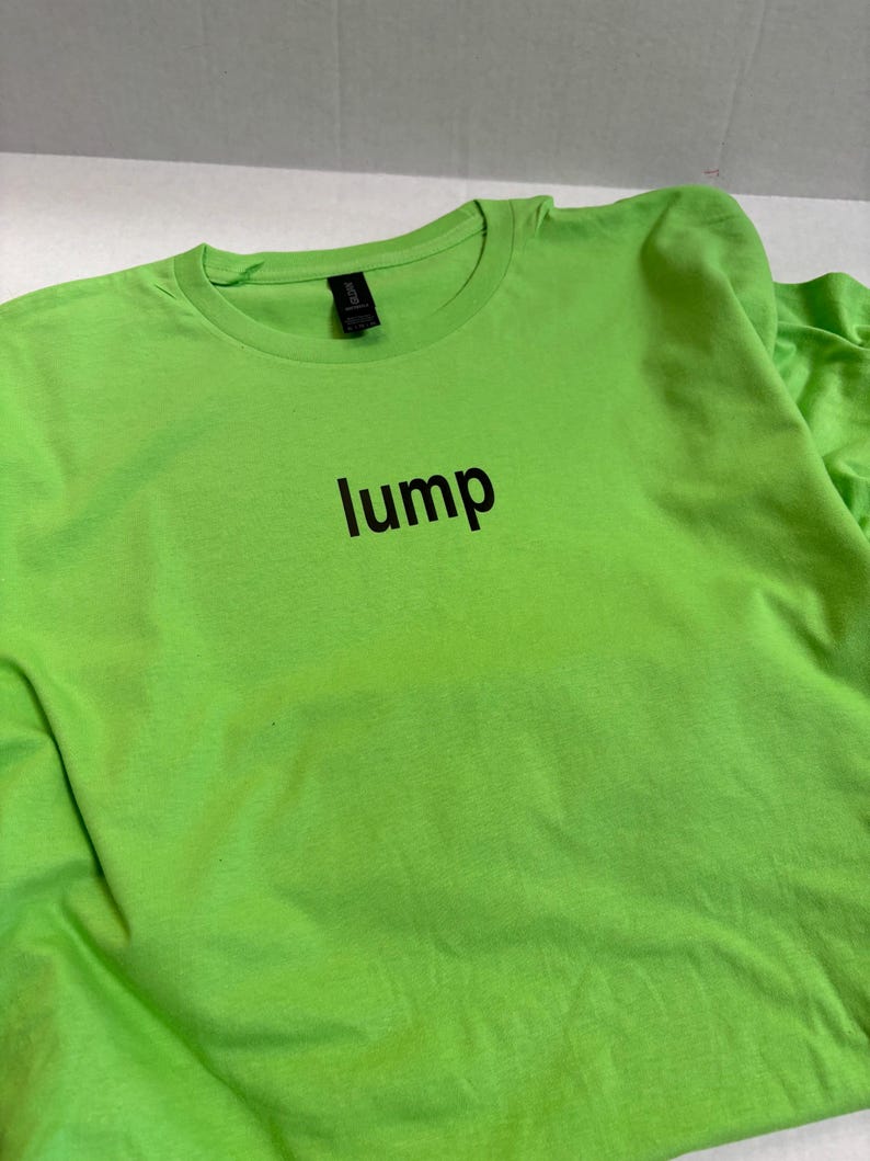 May include: A bright green t-shirt with the word "lump" printed in black on the front.