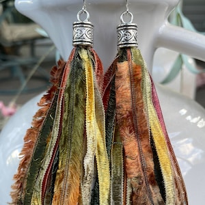 Tassel earrings in shades of green, orange, yellow and a touch of burgundy.