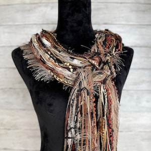 Women's boho fall scarf, versatile and lightweight in shades of copper, black, taupe, orange and cream.