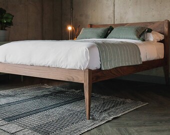 Beautiful, handcrafted, solid wood bed with elegant tapered legs and bold V-patterned headboard