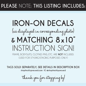 May include: A blue and white sign with the text "PLEASE NOTE: THIS LISTING INCLUDES: IRON-ON DECALS (as displayed in corresponding photo) & MATCHING 8x10" INSTRUCTION SIGN! FRAME, BODYSUITS, CLOTHES PINS, ETC. ARE NOT INCLUDED. (USED FOR STYLING/STAGING PURPOSES ONLY) TAGS SOLD SEPARATELY, SEE DETAILS IN DESCRIPTION BOX shopfreshlypressed.com IG @shopfreshlypressed thank you for stopping by!"