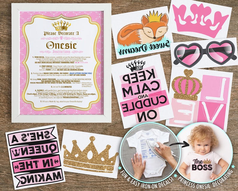 May include: A set of iron-on decals for baby bodysuits featuring a white instruction sign, a sleeping fox with a crown, a pink crown, heart-shaped sunglasses, a Keep Calm and Cuddle On sign, a gold crown, and a She's a Queen in the Making banner.