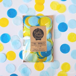 May include: A clear plastic bag filled with blue and yellow paper confetti circles. The bag has a brown label that says "Freshly Pressed" and "Table Sprinkles 1" rounds (approx. 500 pcs.) www.shopfreshlypressed.com"