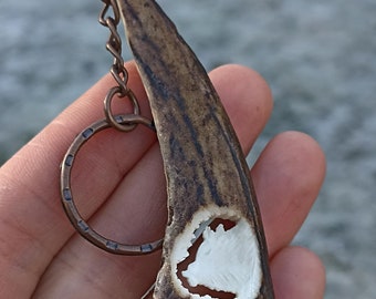 If you are a wild hog hunter, you might like this hand-carved antler keychain.