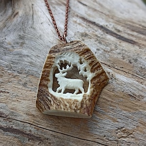 A hand-carved elk keychain or a necklace with a deer