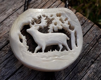 A hand-carved bone bolo tie with a fallow deer
