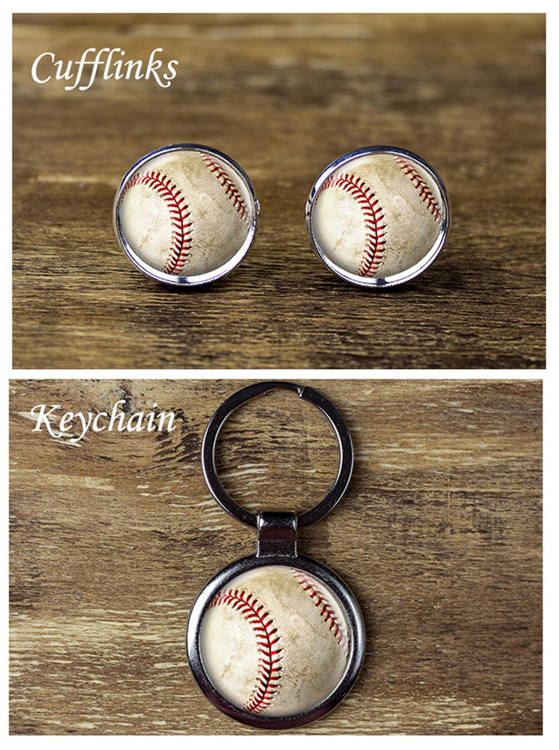 May include: Baseball-themed cufflinks and keychain. The cufflinks feature a baseball design with red stitching and a silver border. The keychain has a similar baseball design with a silver keyring.