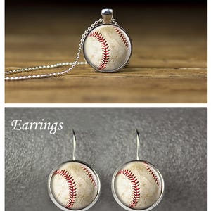 May include: A pendant necklace and earrings featuring a baseball design. The necklace has a silver chain and a round pendant with a baseball image. The earrings are also round with a baseball image and silver hooks. The text "Pendant Necklace" and "Earrings" are visible.